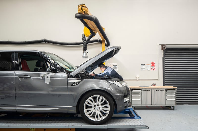 Technician working on Range Rover in aluminium repair bay
